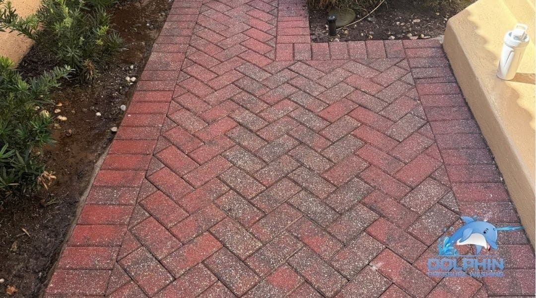 Before and after of a red paver driveway pressure washed in Naples, after